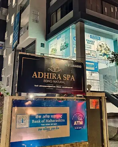 Adhira Spa signboard lit up at night
