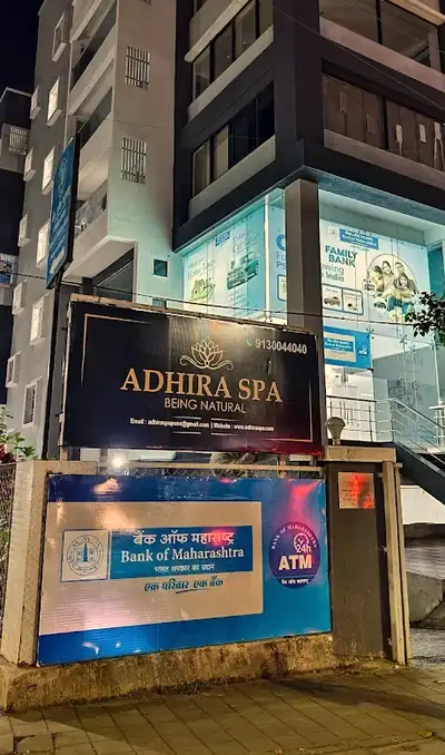 The Adhira Spa signboard lit up at night