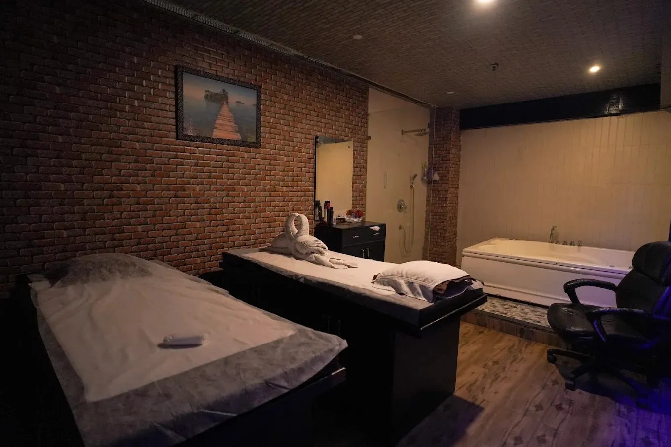 Treatment suite with private jacuzzi and rain shower at Alma Thai Spa